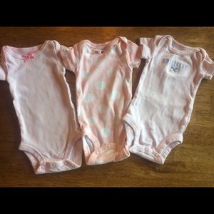 Three pink newborn Carter’s onesies